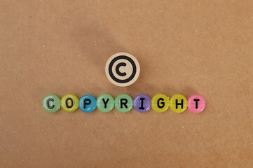Alphabet beads with text COPYRIGHT and letter C.