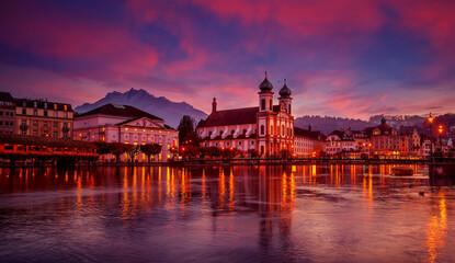Colorful evening view of the Old Town medieval architecture in Lucerne, Switzerland. Dramatic scene with Reuss river, Jesuit church. Wonderful vivid cityscape during sunset. popular travel destination