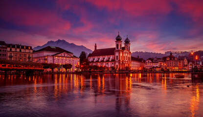 Fototapeta na wymiar Colorful evening view of the Old Town medieval architecture in Lucerne, Switzerland. Dramatic scene with Reuss river, Jesuit church. Wonderful vivid cityscape during sunset. popular travel destination