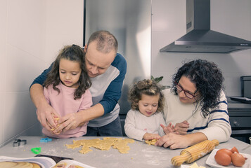 family together making cookies in the kitchen