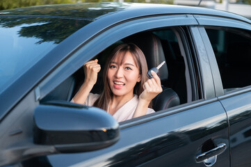 Young asian beautiful woman driving a car with fastened seatbelt