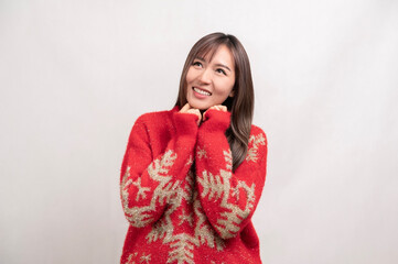 Portrait of young asian woman wearing sweater over white background