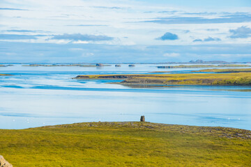 Beautiful Green Valley with Atlantic Ocean in Distant with clear sky and clouds summer in Iceland