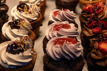 Small cupcakes with different fillings on display.