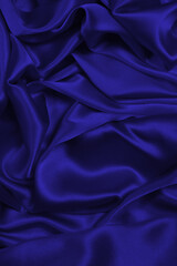 Rich and luxury red silk fabric texture background.