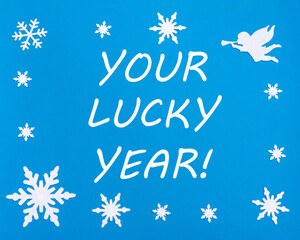 Naklejka na ściany i meble The text is YOUR LUCKY YEAR on a blue background with Christmas snowflakes, a white angel.