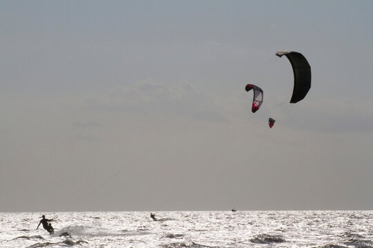 A father and son kite board together on the Pamlico Sound.; Nags Head, North Carolina.