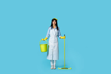 woman in rubber gloves and cleaner apron with cleaning supplies