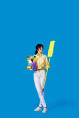 woman in rubber gloves with cleaning supplies