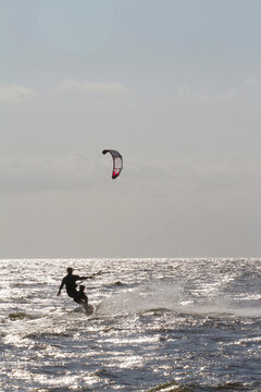 A father and son kite board together on the Pamlico Sound.; Nags Head, North Carolina.