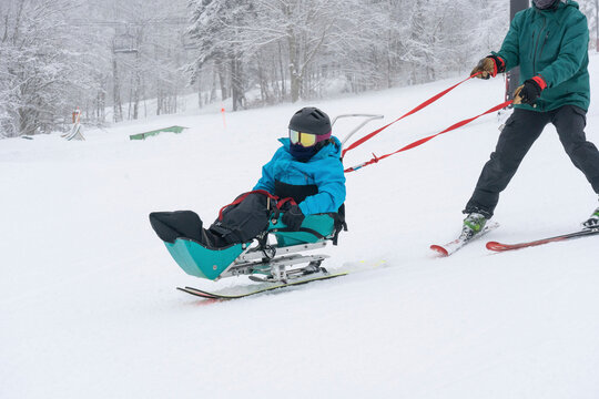 Adaptive skiing for a girl with Ullrich Congenital Muscular Dystrophy, at a ski resort with an instructor; Canaan Valley, West Virginia, United States of America