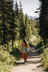 overweight person with backpack walking in the woods. Plus sized model