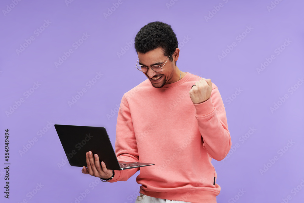 Aufkleber young excited programmer in eyeglasses and pink pullover expressing joy while looking at screen of l