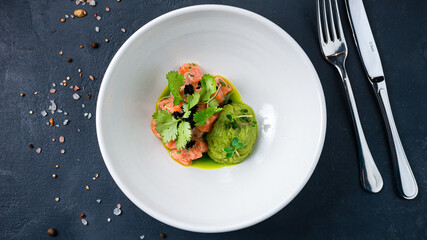 Fresh salmon ceviche with black caviar, microgreens, onion and sauce.