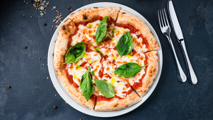 Margarita pizza with mozzarella, tomato sauce, basil on a thick dough with spices.