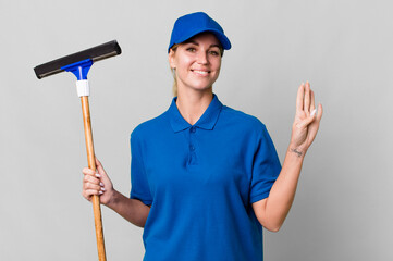 caucasian blonde woman smiling and looking friendly, showing number four. windows washer concept
