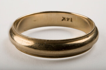 Close-up of a 14K gold wedding band; Studio