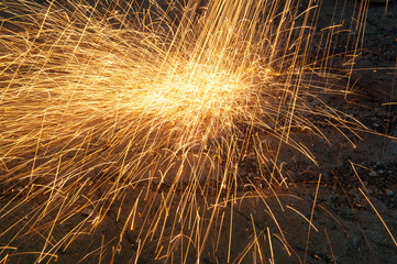 Sparks and light emitted from a cutting torch; Cortland, Nebraska, United States of America