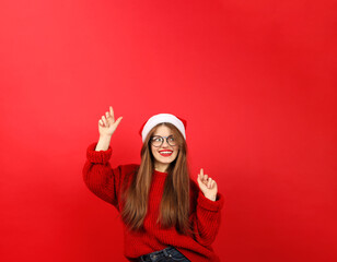 Happy young woman pointing up for a promotional offer on a red background. Promotional offer and sale.