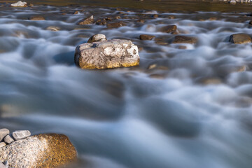 Water flowing over rocks. flowing through the rocks. Long exposure time. Long exposure on the river, Long exposure of the river in the Caucasus mountains. 