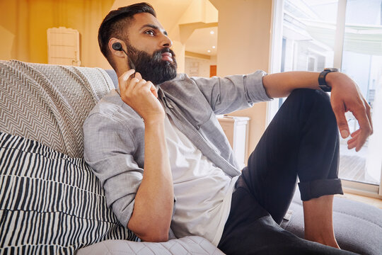 Male relaxing listening to music.
