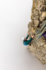 boy climbing on the mountain with foggy background in high altitude