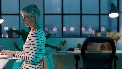 Business or senior woman with laptop at night for calendar schedule, programming or company email. Digital agency, marketing or employee working for research, coding planning or startup data review - Powered by Adobe