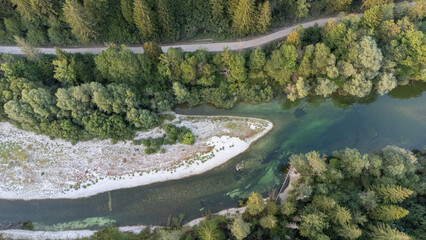 Bird's eye view of river, road and gravel dune