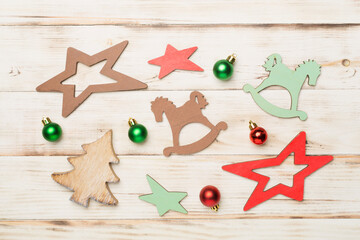 Wooden Christmas toys on color background, top view