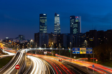  Night photo of the 4 towers in Madrid. Night photo of urban traffic with illuminated buildings.