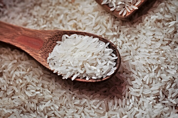 Rice on the table being handled by a wooden spoon. Rice is one of the main sources of carbohydrates and is rich in phosphorus, iron and potassium. In addition, rice does not contain cholesterol.