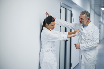 Female doctor rejecting flirty behavior of her male colleague