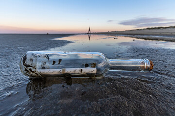 bottle post in the Wadden Sea at sunset