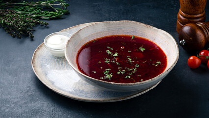 Russian red borscht soup made from beets, potatoes, cabbage, onions and greens with sour cream.