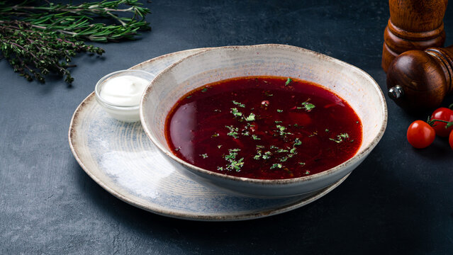 Russian red borscht soup made from beets, potatoes, cabbage, onions and greens with sour cream.
