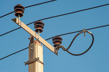Power electric pole with line wire on colored background close up, photography consisting of power...