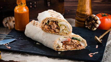 Shawarma from chicken, tomatoes, cucumber, fried onion, lettuce and pita bread.