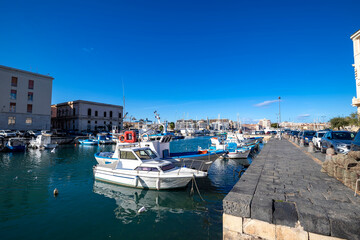 Fototapeta na wymiar sail boats and pleasure boats in old port, seafront of Ortygia (Ortigia) Island in Syracuse (Siracusa), Sicily, Italy
