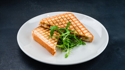 Caprese sandwich with pesto sauce, tomatoes, mozzarella cheese and arugula.