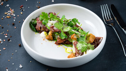 Italian food salad with roast beef, cream cheese, lettuce, spinach, parmesan cheese, parsley and croutons.