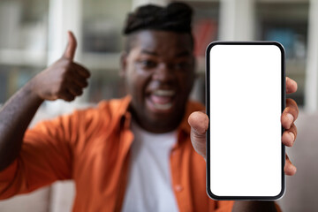 Happy Black Man Showing Big Phone With Empty Screen