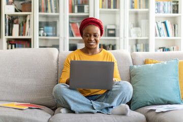 Cheerful african american woman digital nomad working from home