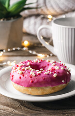 Cozy composition with donut and cup of tea.