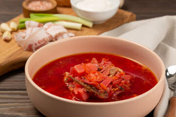 Borscht with cold bacon, green onions, garlic and fresh bread