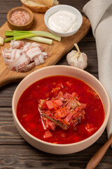 Borscht with cold bacon, green onions, garlic and fresh bread