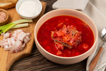 Borscht with cold bacon, green onions, garlic and fresh bread