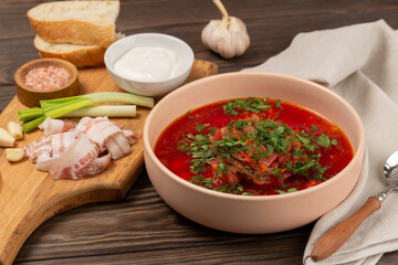 Borscht with cold bacon, green onions, garlic and fresh bread