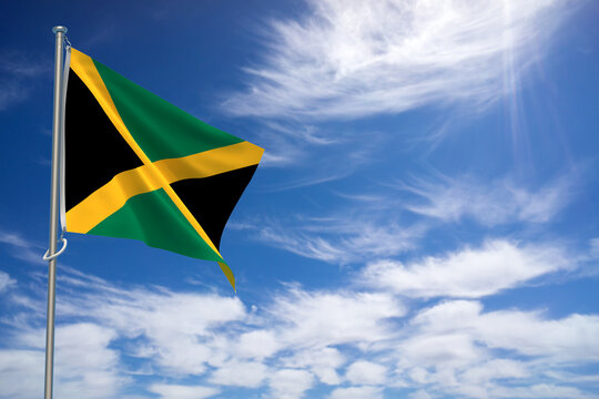 Jamaica flags over blue sky background. 3D illustration