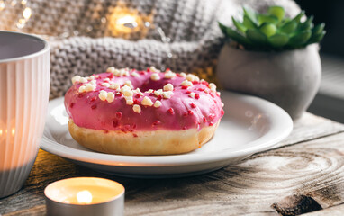 Cozy composition with donut and cup of tea.