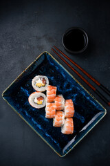 Set of sushi rolls with salmon, cream cheese, mango and shrimp.